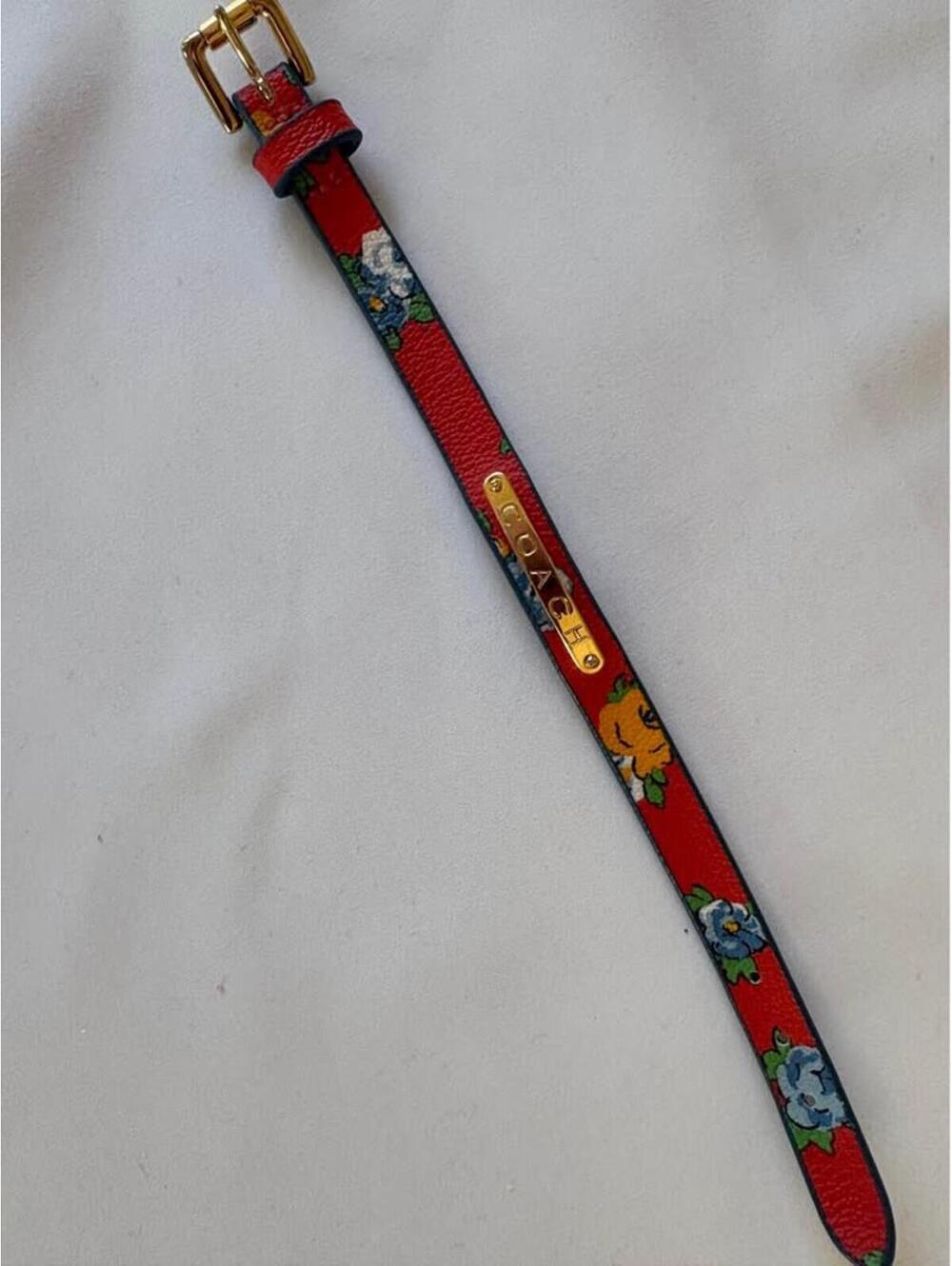 Coach floral leather bracelet with goldtone plate "Coach".